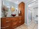 Bright bathroom with a uniquely decorated wall, modern vanity and mirror, and shower at 1 W Canterbury Ln, Phoenix, AZ 85023