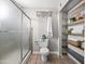 Bright bathroom features tiled floors, glass shower, toilet, and built in shelves with storage at 1 W Canterbury Ln, Phoenix, AZ 85023