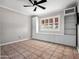 Bedroom with tiled floors, ceiling fan, and a window with white shutters at 1 W Canterbury Ln, Phoenix, AZ 85023