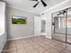 Spacious bedroom featuring tiled floors, ceiling fan, and mirrored closet doors at 1 W Canterbury Ln, Phoenix, AZ 85023