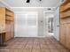Bedroom with hardwood floors, built-in shelving units, and a large closet at 1 W Canterbury Ln, Phoenix, AZ 85023