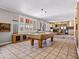 Spacious game room includes a pool table, bar area, and great natural light at 1 W Canterbury Ln, Phoenix, AZ 85023