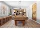 Well-lit game room featuring a pool table, custom built-ins, and plantation shutters at 1 W Canterbury Ln, Phoenix, AZ 85023
