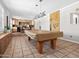 Large game room with a pool table, custom cabinetry, and a nearby bar area at 1 W Canterbury Ln, Phoenix, AZ 85023