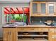 Bright kitchen with open storage and a view to a pool and patio through a large window at 1 W Canterbury Ln, Phoenix, AZ 85023