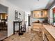 Bright kitchen features wood cabinets, eat-in bar, and unique stone flooring at 1 W Canterbury Ln, Phoenix, AZ 85023