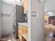 Laundry room with tiled floor, stackable washer and dryer, and storage cabinets at 1 W Canterbury Ln, Phoenix, AZ 85023