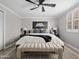 Comfortable bedroom with neutral decor, a ceiling fan, and ample natural light from the window at 1 W Canterbury Ln, Phoenix, AZ 85023