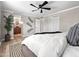 Bright and airy bedroom featuring a ceiling fan, neutral walls, and an ensuite bathroom at 1 W Canterbury Ln, Phoenix, AZ 85023