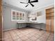 Office space with tiled floors, window, built in shelving units, and office desk at 1 W Canterbury Ln, Phoenix, AZ 85023