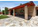 Outdoor patio area featuring a brick outdoor kitchen, dining table, and sitting area at 1 W Canterbury Ln, Phoenix, AZ 85023