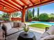Inviting backyard oasis features a sparkling pool, covered patio, and lush landscaping at 1 W Canterbury Ln, Phoenix, AZ 85023