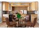 Stylish wet bar area with custom wood cabinetry, seating, and brick backsplash at 1 W Canterbury Ln, Phoenix, AZ 85023