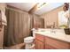 Well-lit bathroom with a sink, toilet, and shower featuring attractive design elements at 10136 E Isleta Ave, Mesa, AZ 85209