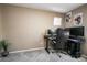 Inviting bedroom featuring neutral walls, plush carpeting, and a dedicated workspace with dual monitors and a comfortable chair at 10136 E Isleta Ave, Mesa, AZ 85209