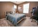 Comfortable bedroom featuring a cozy bed and natural light in a warm setting at 10136 E Isleta Ave, Mesa, AZ 85209