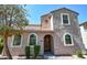 Charming two-story home featuring arched windows, a decorative front door, and well-maintained landscaping at 10136 E Isleta Ave, Mesa, AZ 85209