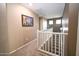 Upstairs hallway featuring stair access, overhead light, and carpet flooring at 10136 E Isleta Ave, Mesa, AZ 85209