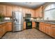 Well-equipped kitchen featuring stainless steel appliances, light wood cabinets, and a granite countertop at 10136 E Isleta Ave, Mesa, AZ 85209