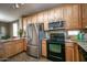 Modern kitchen with stainless steel refrigerator, light wood cabinets, and updated appliances at 10136 E Isleta Ave, Mesa, AZ 85209
