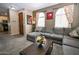 Comfortable living room with a large sectional sofa, hardwood flooring, and modern decor at 10136 E Isleta Ave, Mesa, AZ 85209