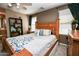 Warm bedroom featuring a cozy bed with decorative pillows, a ceiling fan, and natural light at 10136 E Isleta Ave, Mesa, AZ 85209