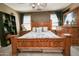 Comfortable main bedroom featuring stylish wood furniture, soft bedding, and ample natural light at 10136 E Isleta Ave, Mesa, AZ 85209