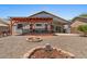 Gravel backyard with a fire pit, pergola, and outdoor seating at 10235 E Jerome Ave, Mesa, AZ 85209