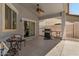 Covered backyard patio featuring a grill, outdoor seating, and stylish décor at 10235 E Jerome Ave, Mesa, AZ 85209