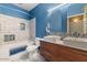 Bathroom showcasing double sinks, tiled shower with glass door and contrasting dark blue painted walls at 10235 E Jerome Ave, Mesa, AZ 85209