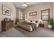 A staged bedroom featuring a neutral palette, carpet flooring, and a large window with stylish window treatments at 10235 E Jerome Ave, Mesa, AZ 85209