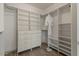 Walk-in closet with custom shelving, drawers, ample storage space, and wood look flooring at 10235 E Jerome Ave, Mesa, AZ 85209