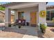 Inviting front porch featuring a cozy bench, potted plants, and a decorative wreath at 10235 E Jerome Ave, Mesa, AZ 85209