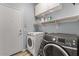 Efficient laundry room with modern washer and dryer and ample storage shelves at 10235 E Jerome Ave, Mesa, AZ 85209