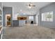 Open-concept living room featuring vaulted ceiling, neutral carpet, and seamless flow into the kitchen area at 10235 E Jerome Ave, Mesa, AZ 85209