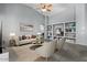 Bright living room with vaulted ceilings, a ceiling fan and built-in shelving at 10235 E Jerome Ave, Mesa, AZ 85209