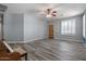 Bright living room featuring plank flooring, a wooden door and a ceiling fan at 10235 E Jerome Ave, Mesa, AZ 85209