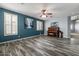 Spacious living room with plank flooring, large windows, and stylish décor at 10235 E Jerome Ave, Mesa, AZ 85209