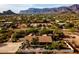 Aerial view of home featuring mountain range, large yard, palm trees, and pool at 10523 E Sleepy Hollow Trl, Gold Canyon, AZ 85118