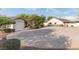 Spacious driveway leading to a well-maintained home with manicured landscaping and a detached garage at 10523 E Sleepy Hollow Trl, Gold Canyon, AZ 85118