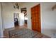 Inviting entryway with a wood door, decorative rug, and views into the living spaces at 10523 E Sleepy Hollow Trl, Gold Canyon, AZ 85118