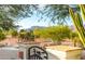 Desert views through iron gate with a saguaro cactus and a southwestern-style property at 10523 E Sleepy Hollow Trl, Gold Canyon, AZ 85118