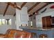 Open kitchen featuring a granite countertop, white cabinets, and wood beam ceiling with a lovely pendant light fixture at 10523 E Sleepy Hollow Trl, Gold Canyon, AZ 85118