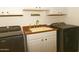 Functional laundry room offering a sink, washer, dryer and cabinet storage at 10523 E Sleepy Hollow Trl, Gold Canyon, AZ 85118