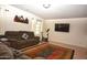 Relaxing living area with a plush sofa, exercise equipment, and a flat-screen TV, perfect for leisure and fitness at 10523 E Sleepy Hollow Trl, Gold Canyon, AZ 85118