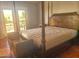 Bright main bedroom features an elegant bed and access to the outdoors through French doors at 10523 E Sleepy Hollow Trl, Gold Canyon, AZ 85118