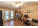 Well-lit office space with tiled floors, a ceiling fan, a computer desk and a bookcase, ideal for work and creativity at 10523 E Sleepy Hollow Trl, Gold Canyon, AZ 85118