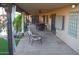 Relaxing covered outdoor patio with desert landscaping, stone flooring, and dining area is perfect for entertaining at 10523 E Sleepy Hollow Trl, Gold Canyon, AZ 85118