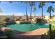 Inviting pool area with lush landscaping and a rock waterfall feature at 10523 E Sleepy Hollow Trl, Gold Canyon, AZ 85118