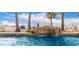 Resort-style pool featuring a rock waterfall and mature palm trees at 10523 E Sleepy Hollow Trl, Gold Canyon, AZ 85118
